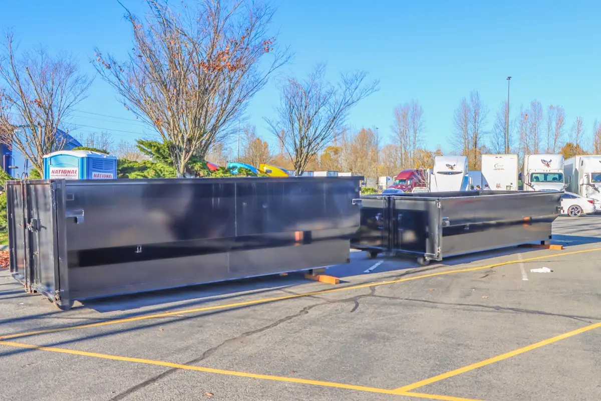 Professional dumpster rental service with roll-off container on residential driveway in Shaker Heights